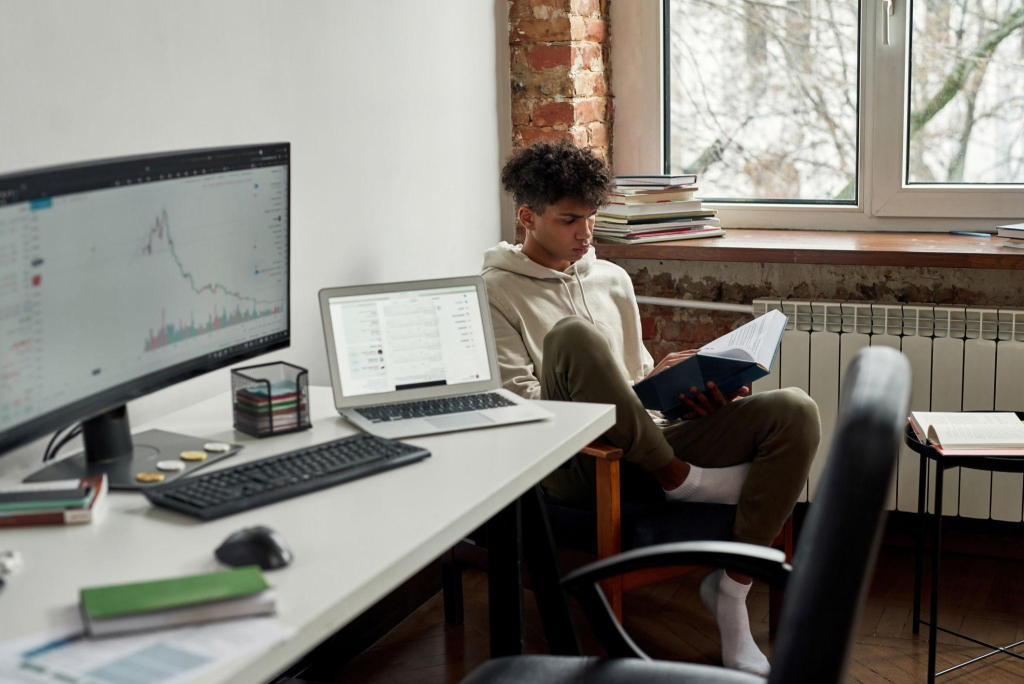 Ethnic young man get passive income trade online while learning