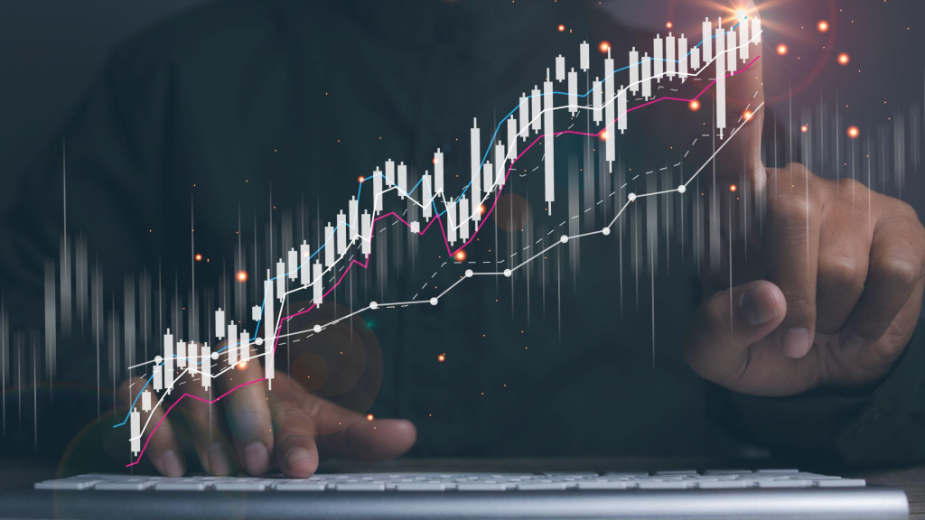 Businessman using laptop with forex trading graph financial data.