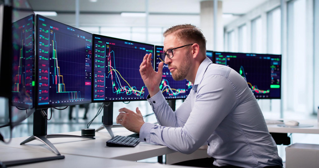 Trader Analyzes Negative Financial Data On Computer Screen